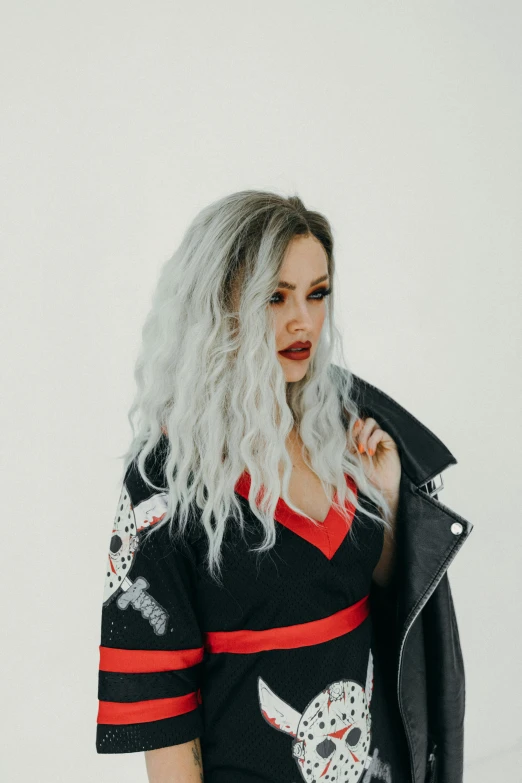 a woman with a white curly hair standing in the snow