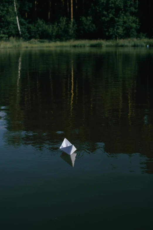 a boat is floating on the water in the dark