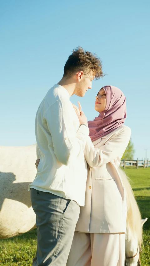 a young couple is walking by the horse together