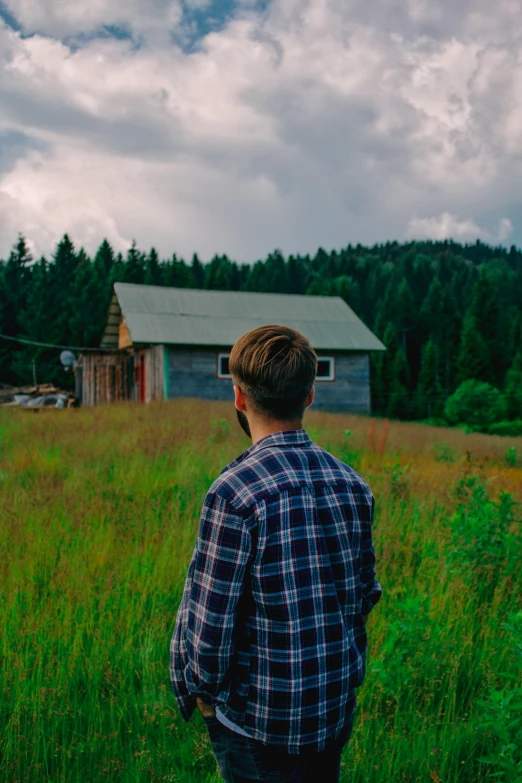 a man that is standing in the grass