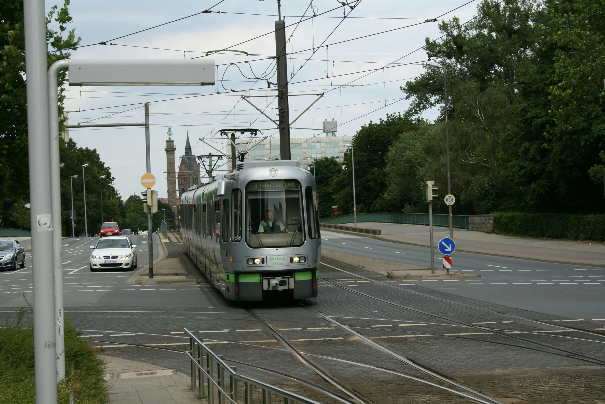 a passenger train on the tracks at an intersection