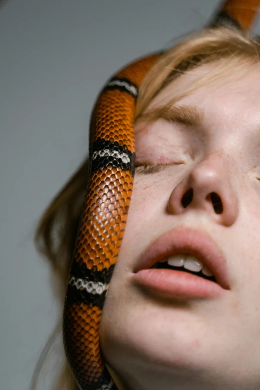 a woman with red eyes and a snake on her neck