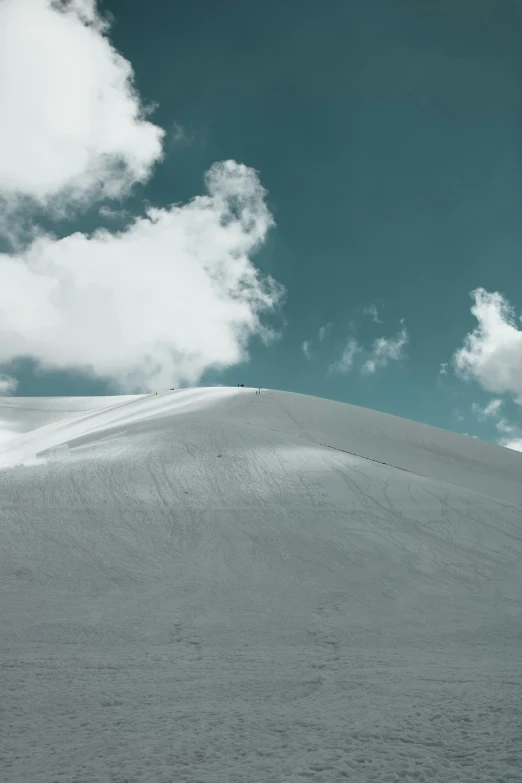 a person standing on top of a snow covered hill