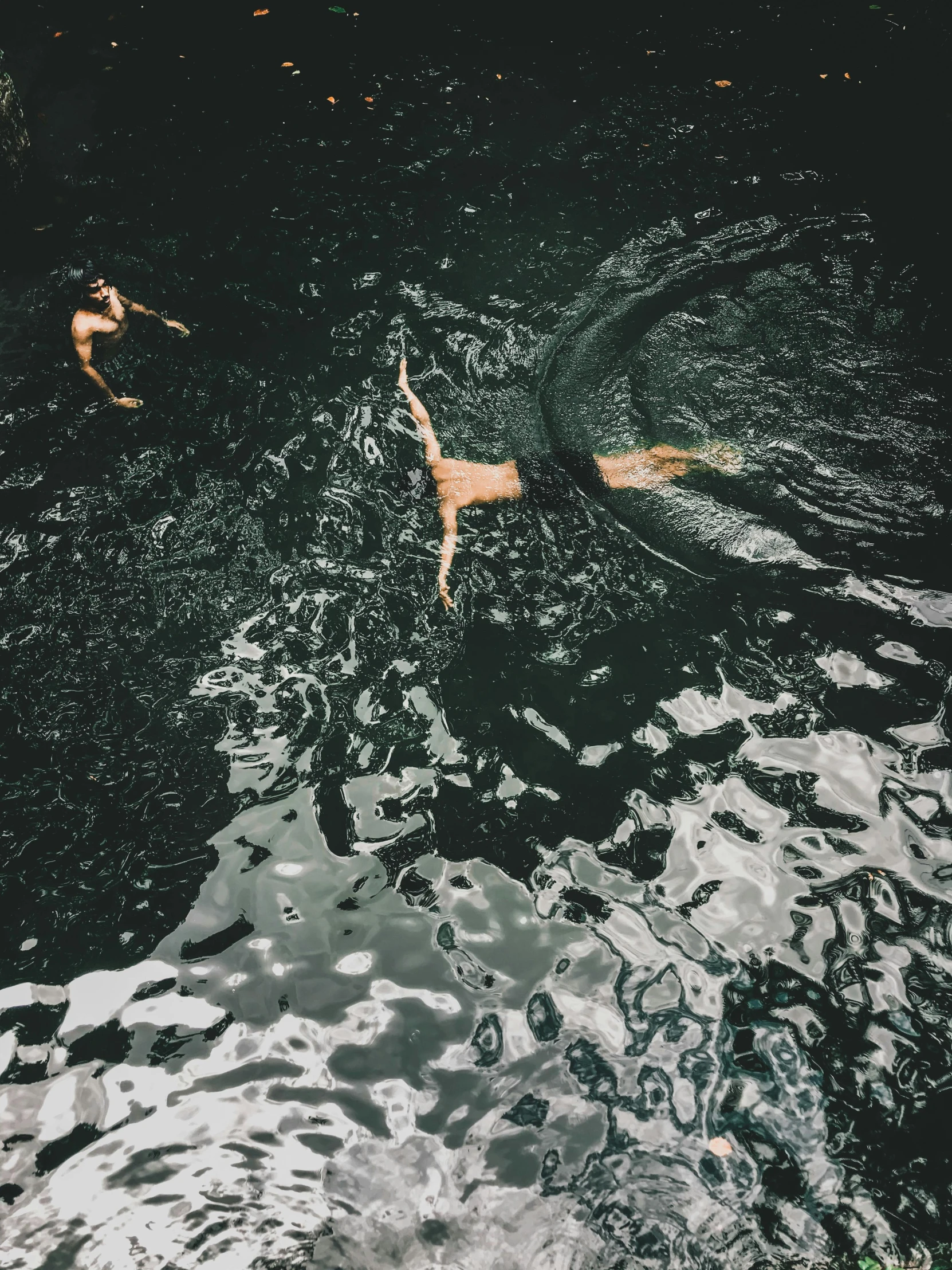 two people floating on top of a lake