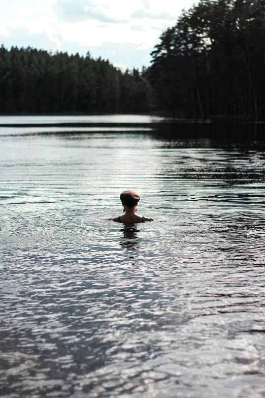 a young man swimming in the lake with no water