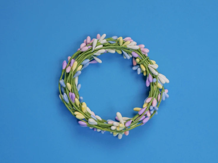 flowers are pinned together in a circular on a blue background