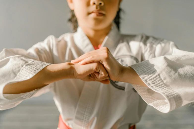 someone holding hands together while wearing a white shirt