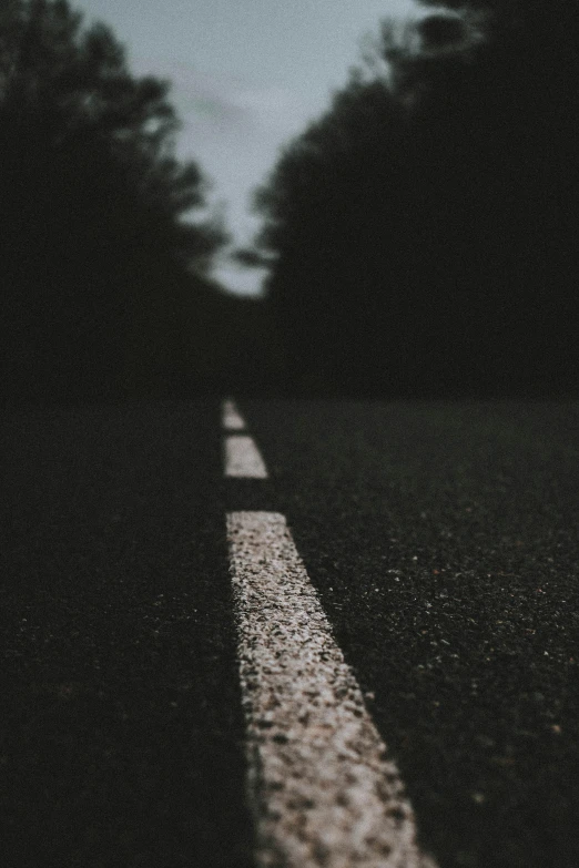 there is a black and white street sign on the side of the road