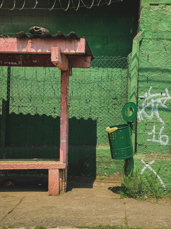 an old green building with grass around it