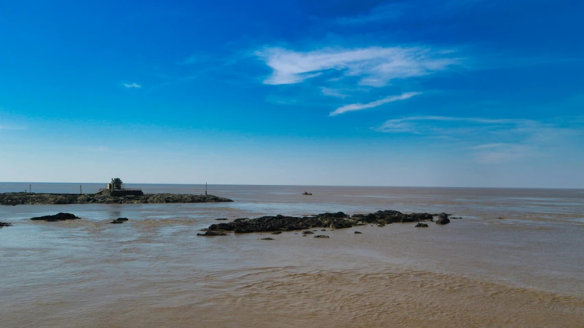 the lighthouse on the island is near the water