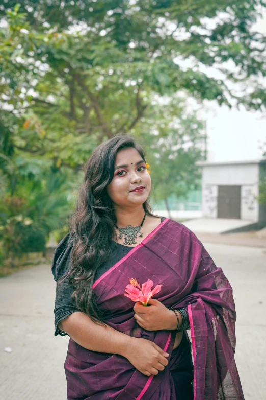 a woman in purple and black clothing posing for the camera