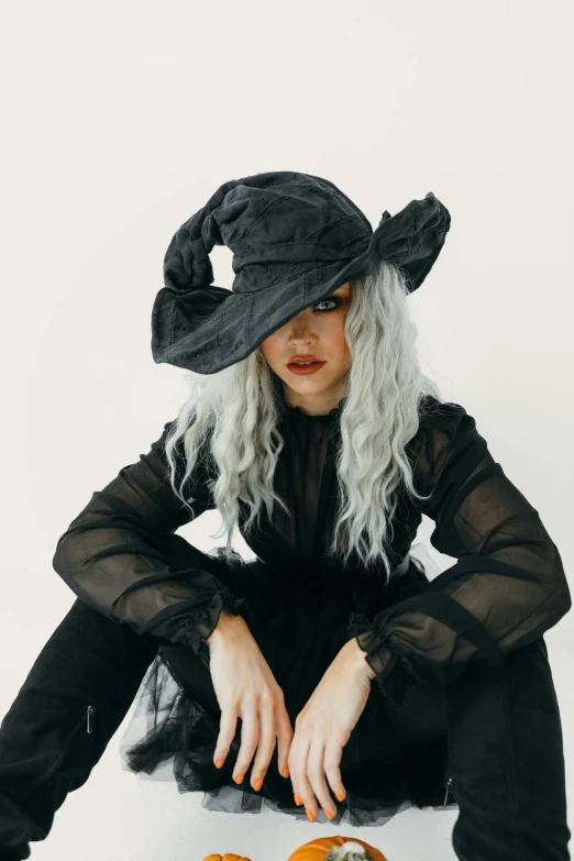 woman wearing black clothing and bonnet over white background