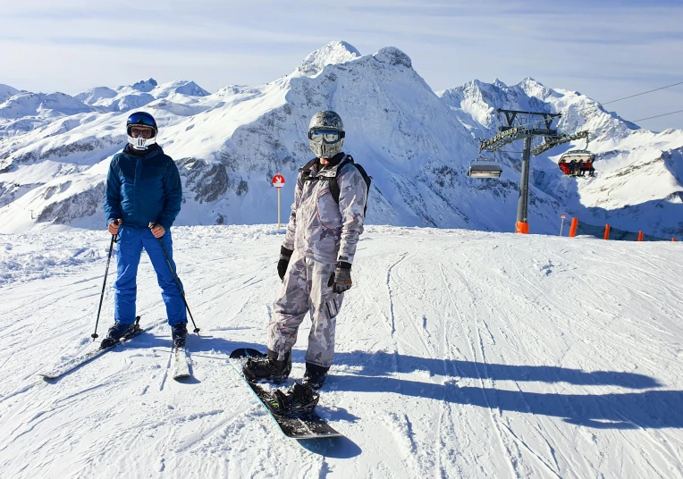 two people are standing on skis in the snow