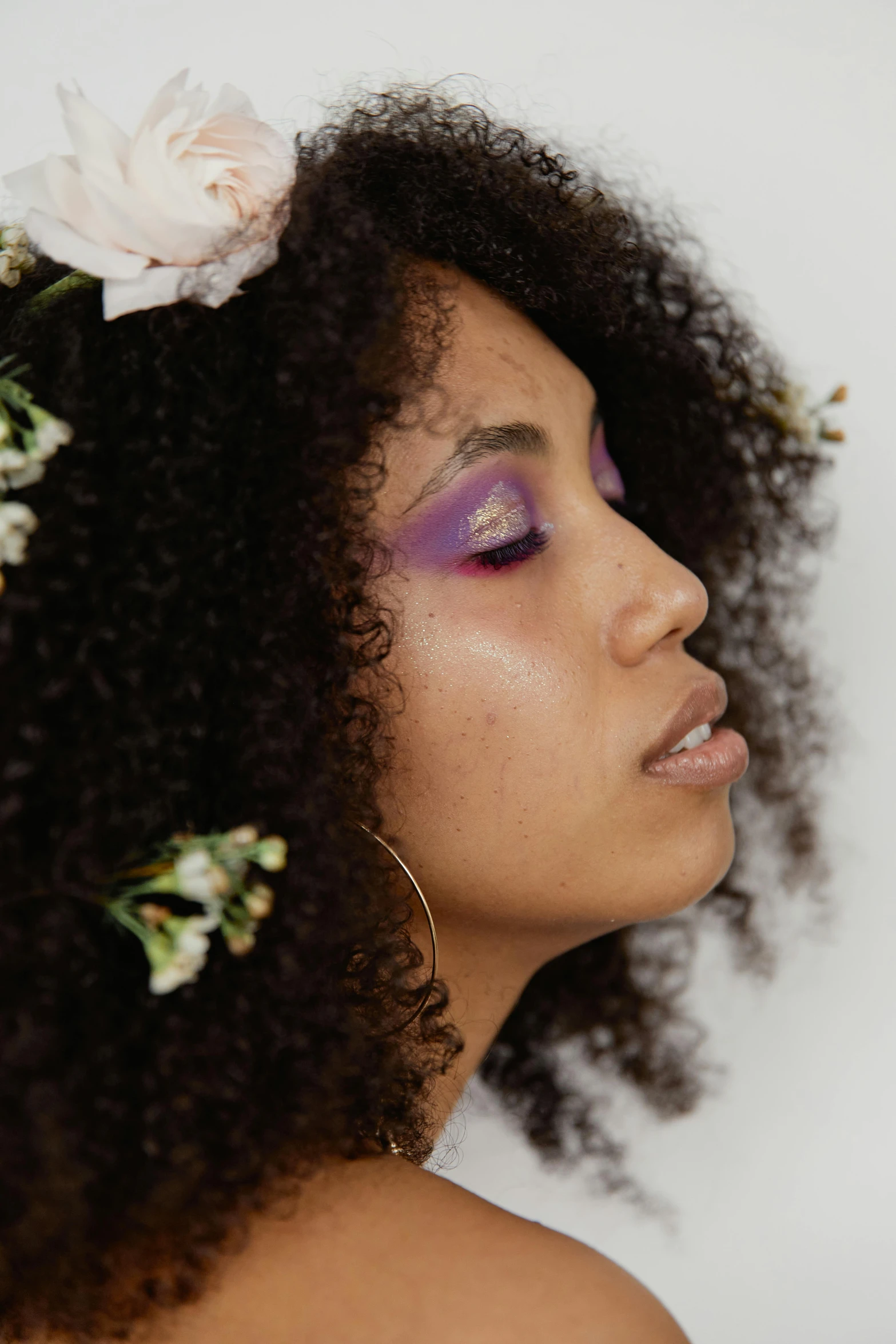 a close up of a person with a flower in their hair