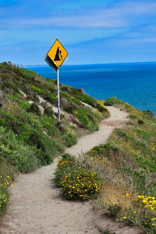 an arrow pointing left in front of a caution sign