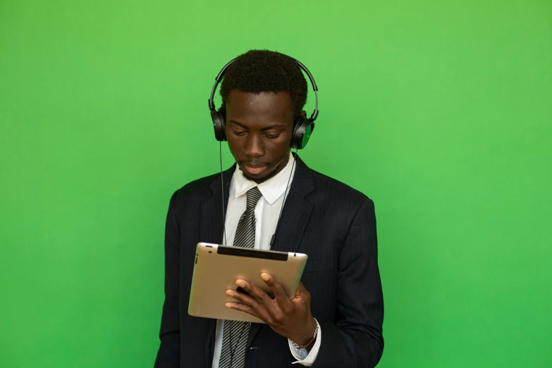 a man in a suit using an ipad computer