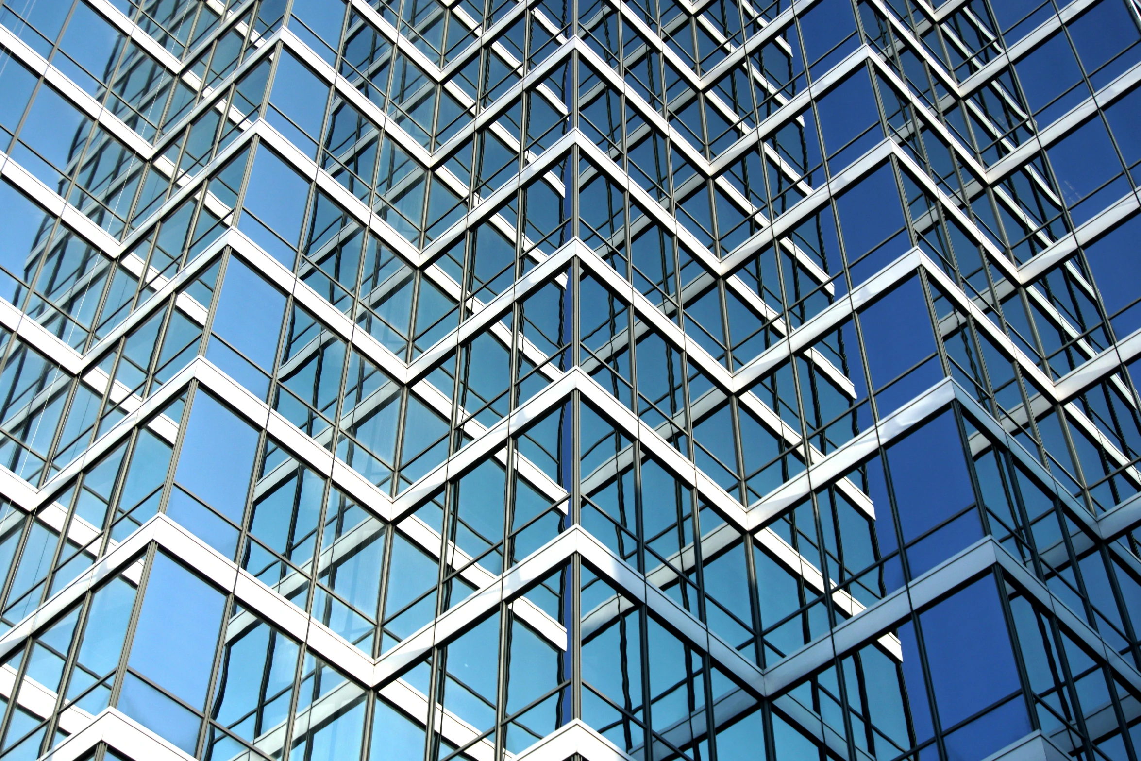 the top part of a glass office building's face