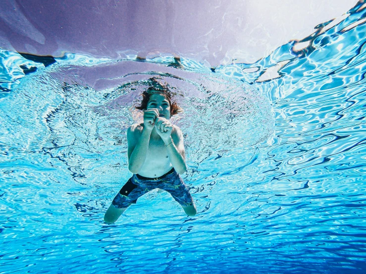 a man swimming with his head under the water