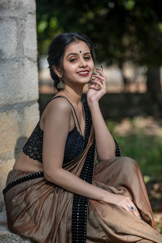 a young woman poses for a picture in an indian attire