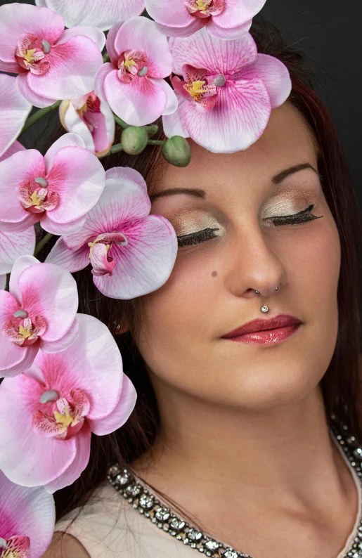 a beautiful woman with white flowers around her head