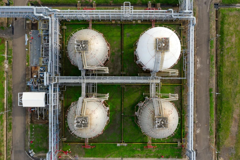 three large tanks in an industrial setting