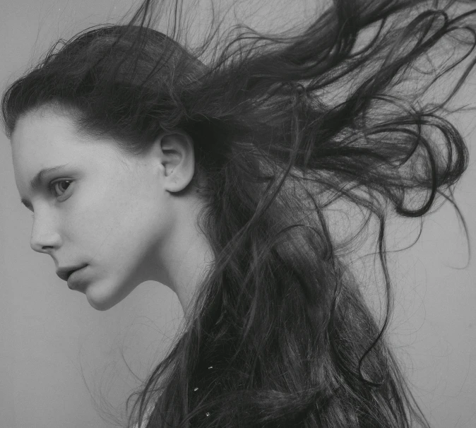 a woman with her hair flying into the air