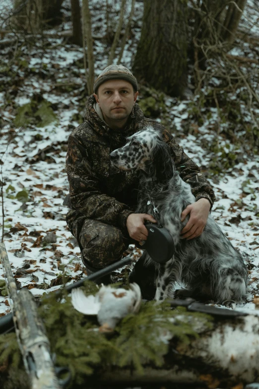 a man with two dogs in the woods