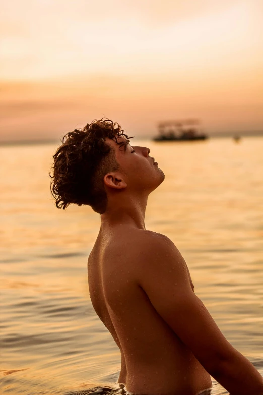 young man in swimming suit standing in water