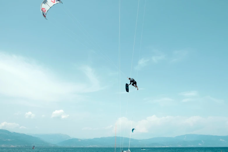 a few people in the water flying kites