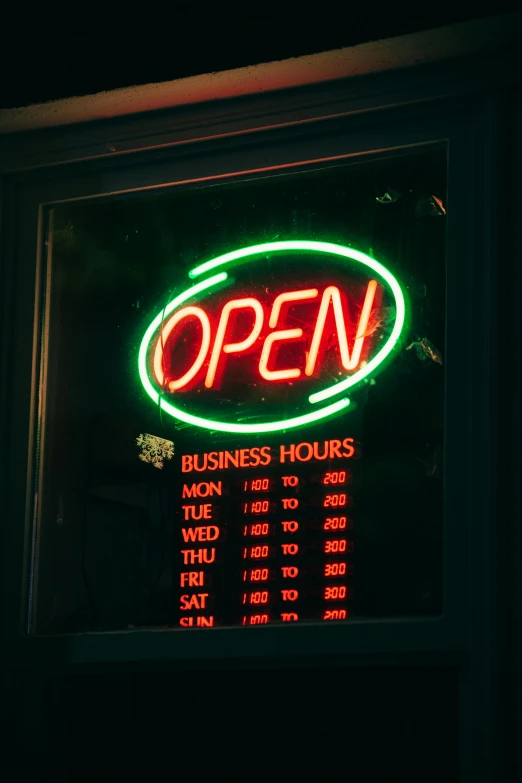 the sign for open in the window says business hours