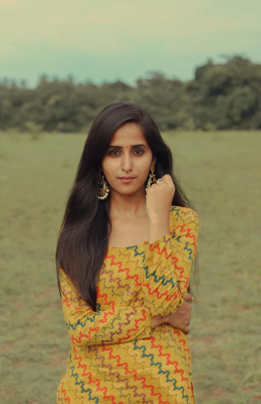 a beautiful young lady standing in a field