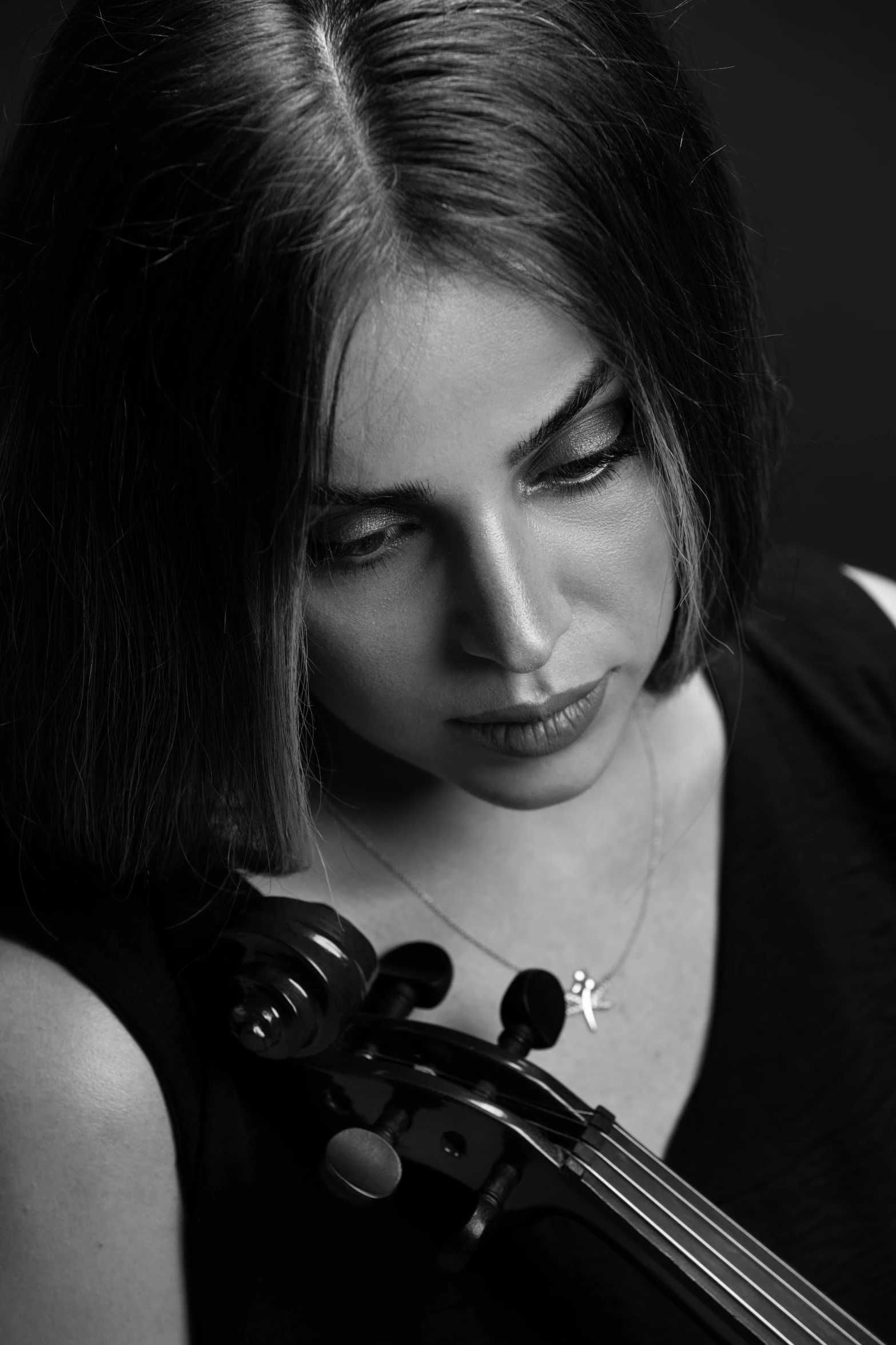 a woman in black shirt playing the violin