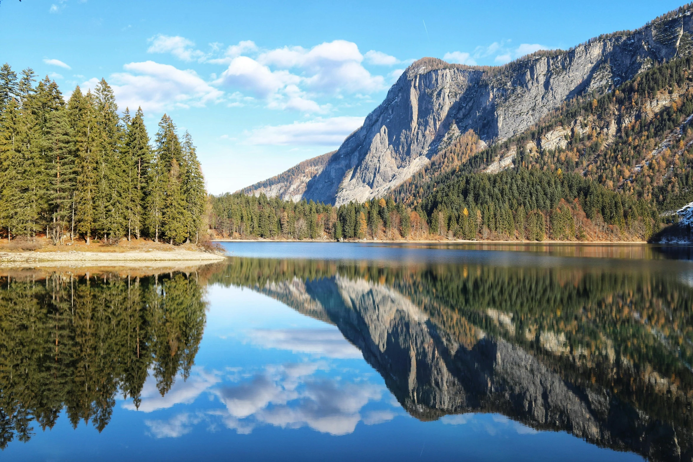 a reflection of the mountain in a lake