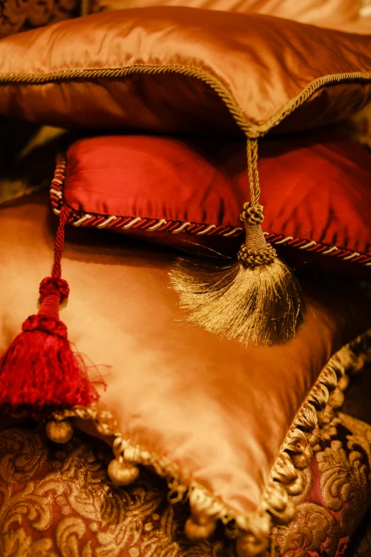 pillows and blankets with a tasselled cushion are shown