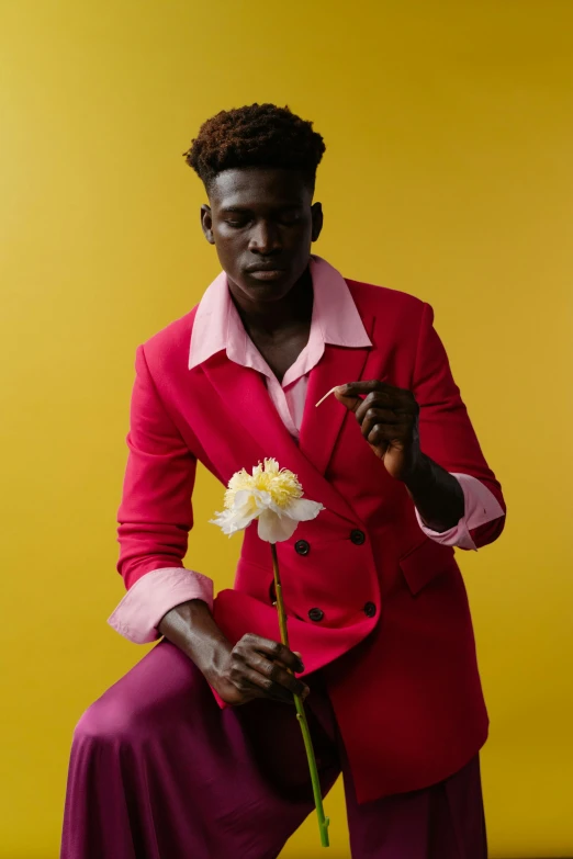 a person kneeling with a flower in their lap