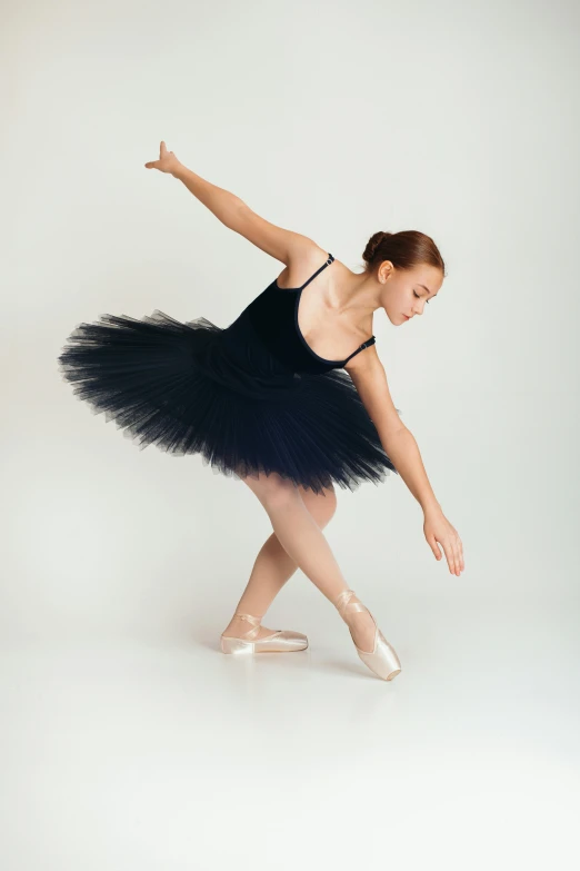 a ballet student in black dress dancing