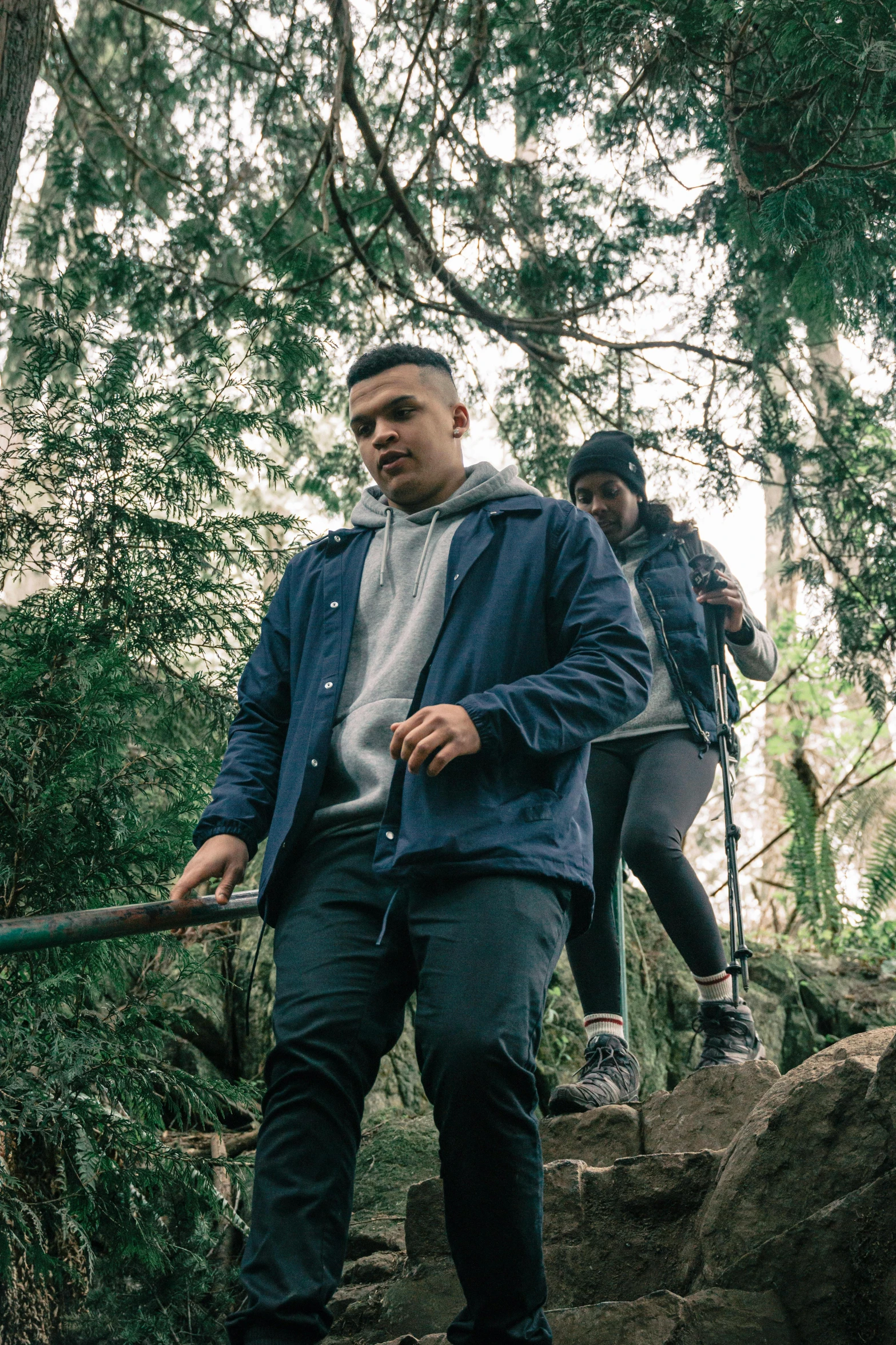 two people walk up stairs in the woods