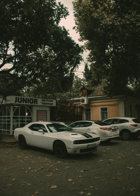 several cars are parked in front of a small store