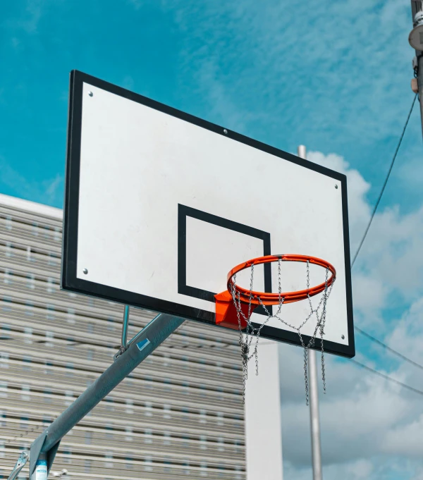 basketball hoop and net on street side next to building