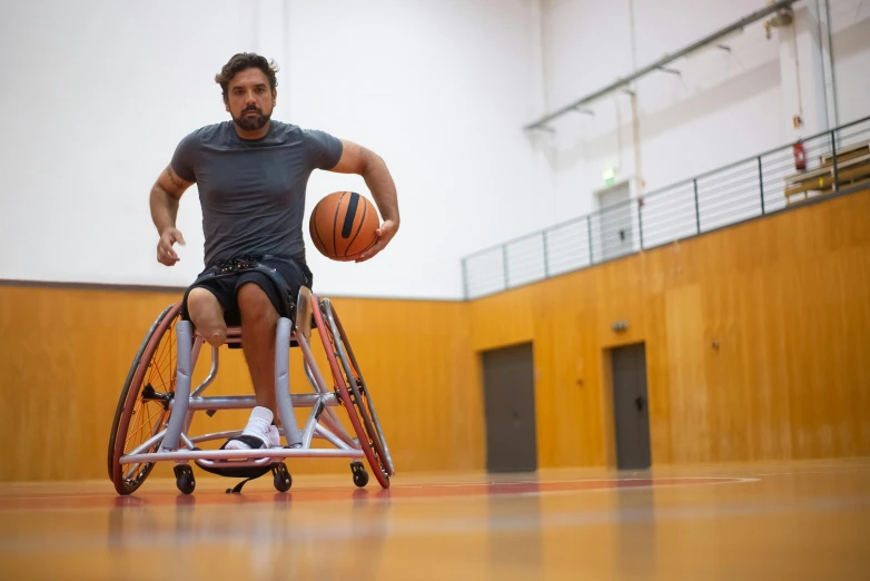 a man in a wheelchair holding a basketball