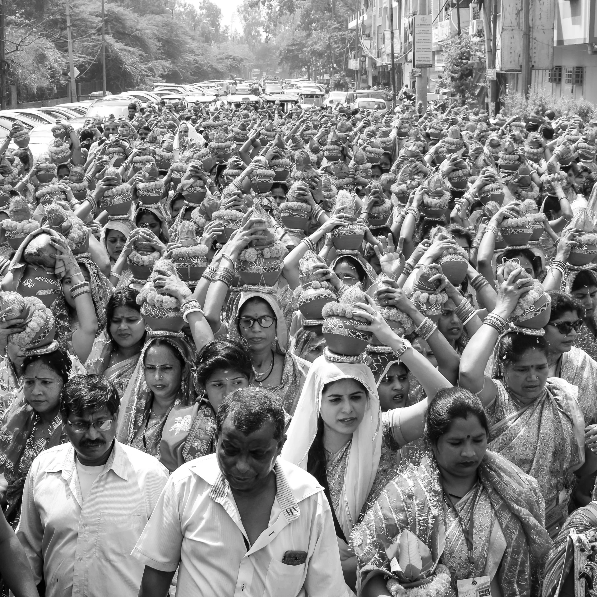 many women wearing dresses standing together and holding up their hands