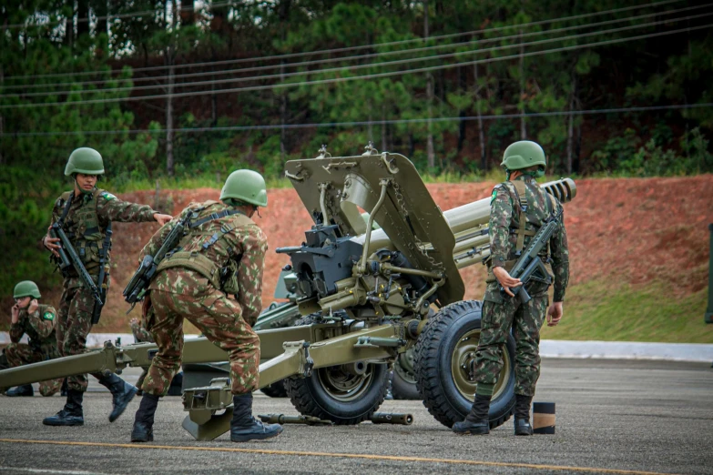 several military personnel are doing soing to a vehicle