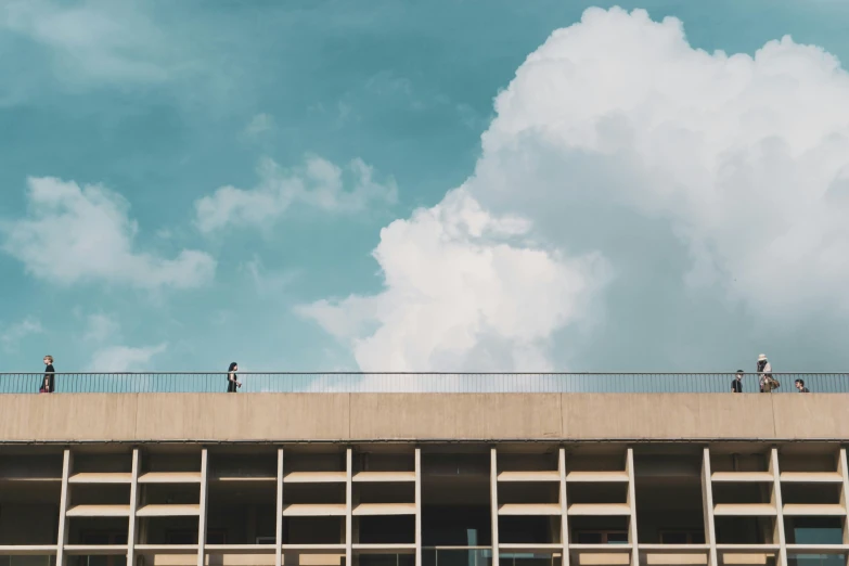 two men are standing on a high ledge near a clock