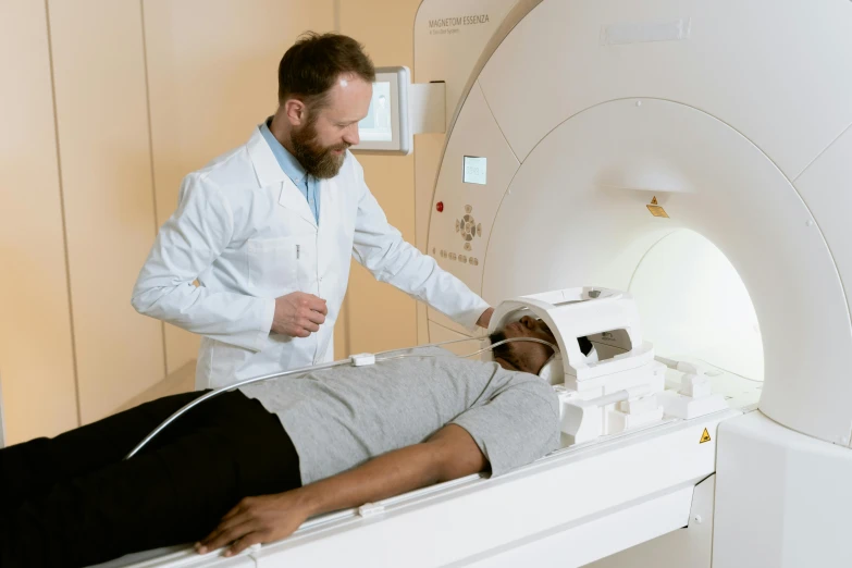 a doctor is laying in a hospital bed with an instrument