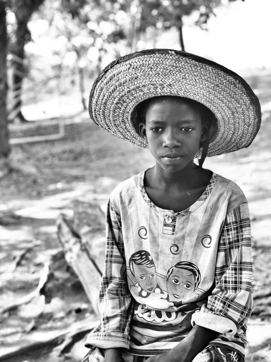 a black and white po of a girl wearing a hat