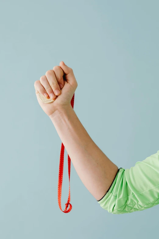 the arm and armband of someone holding a string