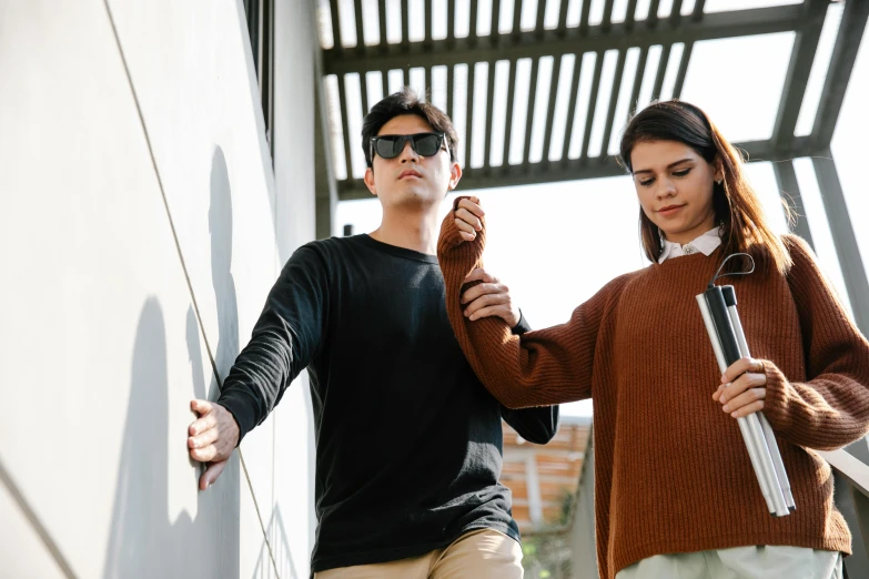 a man holding onto the straps of a young woman