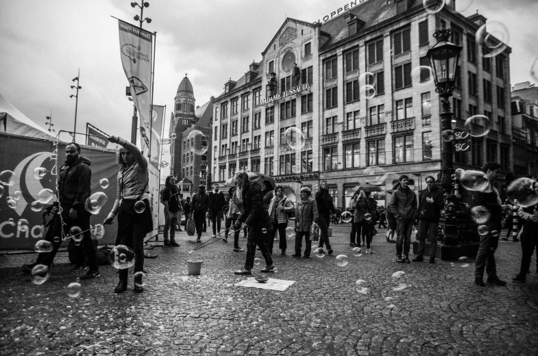 this is an old black and white po of people blowing bubbles