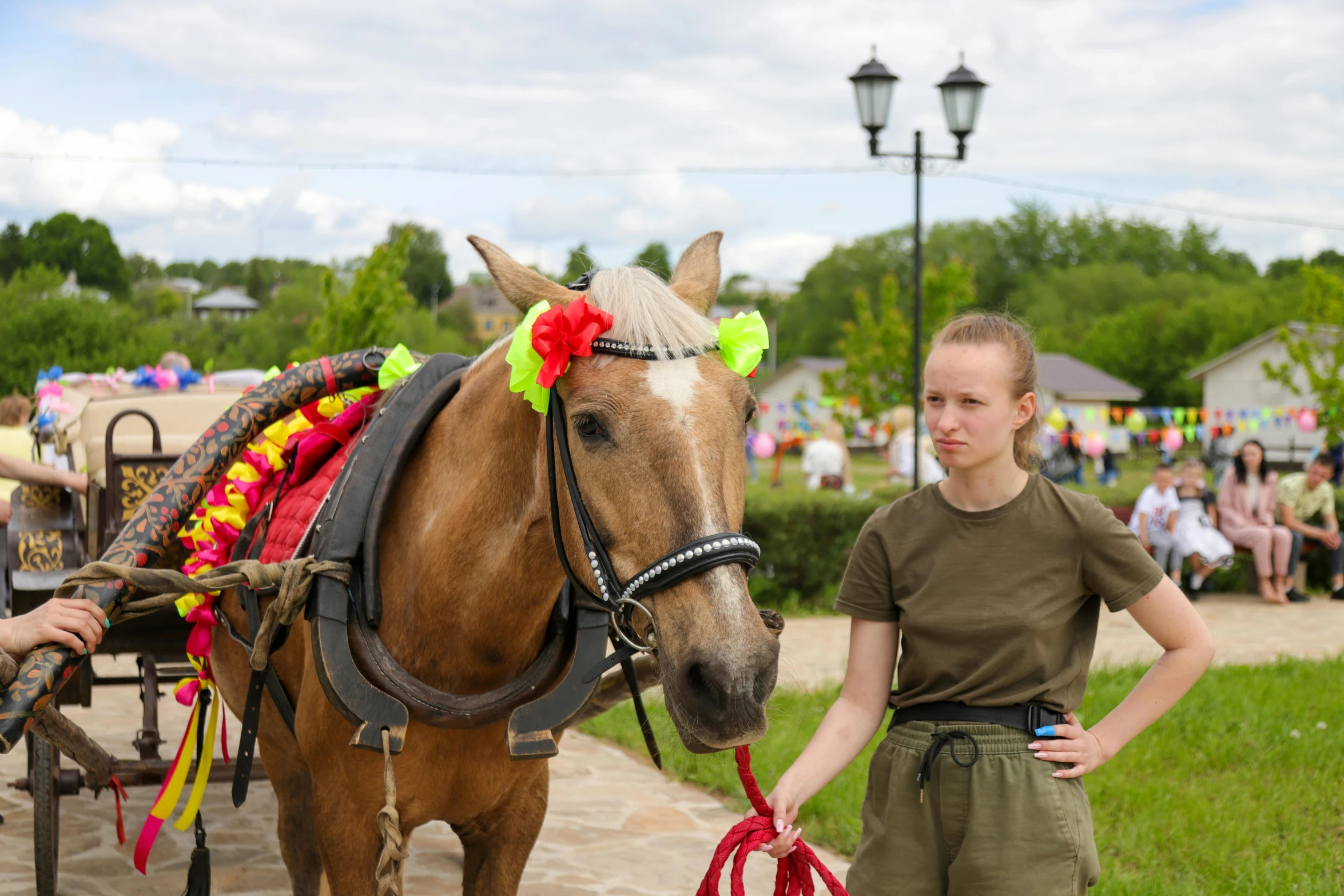 a young lady standing next to a horse