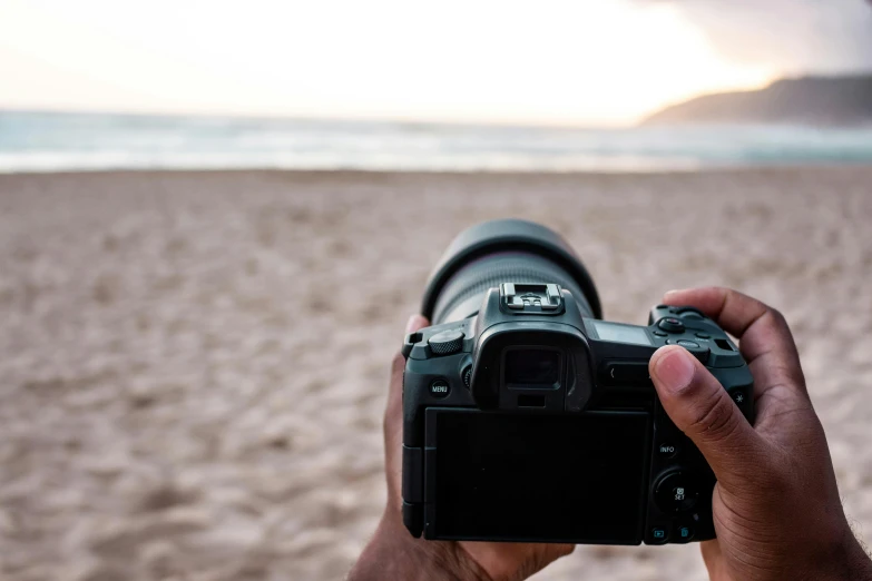 someone taking a picture of a beach with a camera